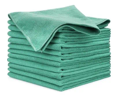 A stack of green microfiber cloths used in auto detailing training on a white background.