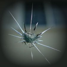 An image of a broken glass in a window undergoing windshield repair.